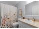 Bathroom with a mirror, a vanity and sink with a shower/tub with a curtain at 841 Eagles Lndg, Leesburg, FL 34748