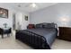 Relaxing bedroom with tile floors and ceiling fan leading to bathroom and closet spaces at 841 Eagles Lndg, Leesburg, FL 34748