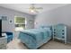 Bright bedroom with a ceiling fan, dresser and a window allowing natural light to enter the room at 841 Eagles Lndg, Leesburg, FL 34748