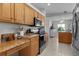 Functional kitchen showcasing wooden cabinets, modern appliances, and ample counter space at 841 Eagles Lndg, Leesburg, FL 34748