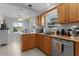 Bright kitchen with wood cabinets, ample counter space, and a view to the breakfast nook at 841 Eagles Lndg, Leesburg, FL 34748