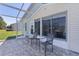 Back patio seating area with a view of the backyard and a lovely spot for relaxation at 841 Eagles Lndg, Leesburg, FL 34748