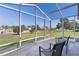 Enjoy backyard views from this screened lanai with plenty of room for outdoor seating at 841 Eagles Lndg, Leesburg, FL 34748