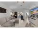 Bright and airy living room with comfortable seating, tile floors, and a view to the sunroom at 841 Eagles Lndg, Leesburg, FL 34748