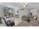 Cozy living room with tile flooring, comfortable seating, and a view of the dining area at 841 Eagles Lndg, Leesburg, FL 34748