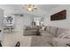 Inviting living area with a large sectional sofa and view of the dining room at 841 Eagles Lndg, Leesburg, FL 34748