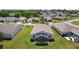 A beautiful aerial view of the back of the house, showing a screened-in lanai and green lawn at 841 Eagles Lndg, Leesburg, FL 34748