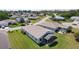 Aerial view of a well-maintained home highlighting the screened-in lanai and lush green lawn at 841 Eagles Lndg, Leesburg, FL 34748