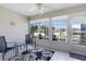 Enclosed sunroom featuring tiled flooring, ceiling fan, and large windows with backyard views at 841 Eagles Lndg, Leesburg, FL 34748