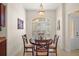 Cozy dining area with a round wood table and shuttered windows for natural light at 859 Parksville Path, The Villages, FL 32162