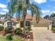 Charming single-story home with well-maintained landscaping and a welcoming two-car garage at 859 Parksville Path, The Villages, FL 32162