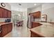 Well-lit kitchen with wood cabinets, stainless steel appliances, and a breakfast nook at 859 Parksville Path, The Villages, FL 32162