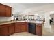 Kitchen featuring wood cabinets, breakfast bar, and an open view to the living spaces at 859 Parksville Path, The Villages, FL 32162