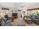 Comfortable living room with plush seating, a ceiling fan, and natural light at 859 Parksville Path, The Villages, FL 32162