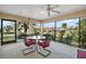 Screened patio with a table and chairs, and views of the landscaped surroundings at 859 Parksville Path, The Villages, FL 32162