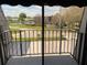 This balcony overlooks a serene pond and lush landscaping, offering a peaceful outdoor space at 1000 Royal Oak Blvd, Leesburg, FL 34748