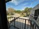 Balcony view with a street, mature trees and neighborhood buildings on a sunny day at 1000 Royal Oak Blvd, Leesburg, FL 34748
