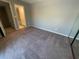 This bedroom offers comfortable carpeting and easy access to the en-suite bathroom at 1000 Royal Oak Blvd, Leesburg, FL 34748
