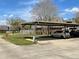 Carport with multiple parking spots, and a fire hydrant in the grassy common area at 1000 Royal Oak Blvd, Leesburg, FL 34748