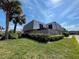 Exterior view of a townhouse with a balcony and lush landscaping at 1000 Royal Oak Blvd, Leesburg, FL 34748