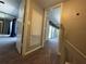 Hallway features carpeted floors leading to the bedrooms with access to an outdoor balcony at 1000 Royal Oak Blvd, Leesburg, FL 34748