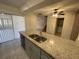 Granite countertop island overlooking a kitchen area, stainless steel appliances, and backyard at 1000 Royal Oak Blvd, Leesburg, FL 34748