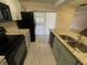 Modern kitchen featuring granite countertops, stainless steel appliances, and gray cabinetry at 1000 Royal Oak Blvd, Leesburg, FL 34748