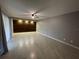 Spacious living room with recessed lighting, wood-look accent wall, and tile flooring at 1000 Royal Oak Blvd, Leesburg, FL 34748