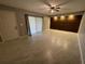 Bright living area with sliding glass doors, wood accent wall, recessed lighting, and tile floors at 1000 Royal Oak Blvd, Leesburg, FL 34748