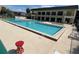Community pool with a large pool deck, multiple chaise lounges and umbrellas at 1000 Royal Oak Blvd, Leesburg, FL 34748