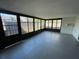 Enclosed sunroom featuring a tile floor, multiple windows, and outdoor access at 1000 Royal Oak Blvd, Leesburg, FL 34748
