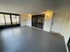 Enclosed sunroom featuring a tile floor, multiple windows, and access to a doorway at 1000 Royal Oak Blvd, Leesburg, FL 34748
