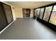 Enclosed sunroom featuring a tile floor, multiple windows, and access to the home at 1000 Royal Oak Blvd, Leesburg, FL 34748