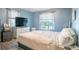 Comfortable bedroom with natural light, modern dresser, and laminate floors at 102 S Sunland Dr, Sanford, FL 32773