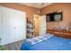 This bedroom offers a closet, tv, and dark wooden dresser for storage at 102 S Sunland Dr, Sanford, FL 32773