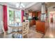 Bright dining area with a window and a breakfast bar leading into the kitchen at 102 S Sunland Dr, Sanford, FL 32773