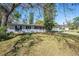 Charming single-story home featuring a manicured lawn and mature trees at 102 S Sunland Dr, Sanford, FL 32773