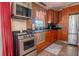 Kitchen features stainless steel appliances, modern countertops, and a mosaic backsplash at 102 S Sunland Dr, Sanford, FL 32773