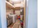 Functional laundry room with washer, dryer, storage shelves, and utility space at 102 S Sunland Dr, Sanford, FL 32773