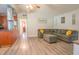 Open concept living room with hardwood floors, a large sectional, and easy access to the kitchen at 102 S Sunland Dr, Sanford, FL 32773