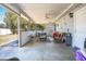 The covered patio offers an outdoor dining table and comfortable seating area at 102 S Sunland Dr, Sanford, FL 32773