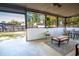 A screened patio offers an outdoor dining table and access to the backyard at 102 S Sunland Dr, Sanford, FL 32773