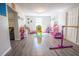 Spacious playroom with hardwood floors, lots of colorful toys, and access to living room at 102 S Sunland Dr, Sanford, FL 32773