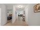 Inviting hallway with tile flooring leading to living spaces, and a bedroom on the left at 1020 Calico Pointe Cir, Groveland, FL 34736