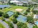 Aerial view of community amenities including a baseball field, tennis courts, and shuffleboard courts at 11743 Se 174Th Loop, Summerfield, FL 34491