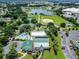 Community aerial view showcasing a lake, baseball field, pool, tennis courts, and clubhouse at 11743 Se 174Th Loop, Summerfield, FL 34491