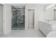 Contemporary bathroom with a glass shower, double vanity, and bright lighting at 11743 Se 174Th Loop, Summerfield, FL 34491