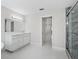 Contemporary bathroom with a double vanity, walk-in glass shower, and bright lighting at 11743 Se 174Th Loop, Summerfield, FL 34491