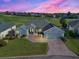 Beautiful single-story home with lush landscaping, brick driveway, and a two-car garage at 11743 Se 174Th Loop, Summerfield, FL 34491