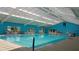 Bright and spacious indoor pool area with ample natural light, providing year-round swimming enjoyment at 11743 Se 174Th Loop, Summerfield, FL 34491